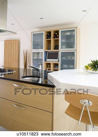 Small circular underset sinks in black granite worktop on island unit in modern kitchen View Large Photo Image Stock Image - Small circular underset sinks in black granite worktop on island unit in modern kitchen. Fotosearch