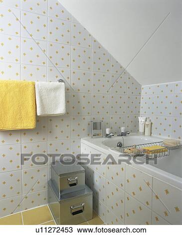 Stock Image - Small white+yellow tiled attic bathroom. Fotosearch