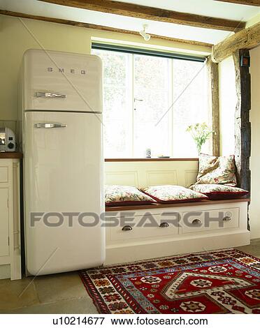 Smeg Fridge Freezer Beside Window Seat With Storage Drawers In