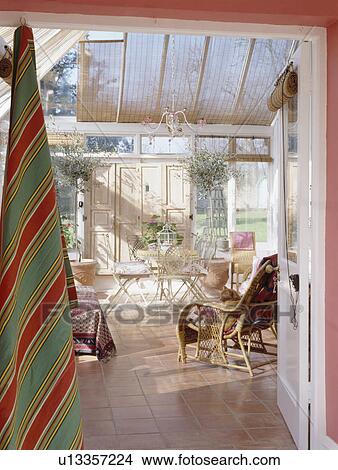 Split cane blinds on roof of conservatory dining room with wooden flooring View Large Photo Image Picture - Split cane blinds on roof of conservatory dining room with wooden flooring. Fotosearch