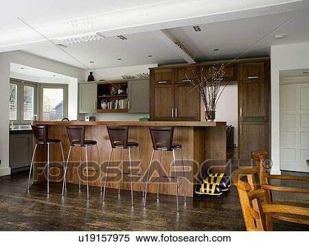 Stainless steel and black leather stools at island breakfast bar in modern white kitchen extension View Large Photo Image Stock Photography - Stainless steel and black leather stools at island breakfast bar in modern white kitchen extension. Fotosearch