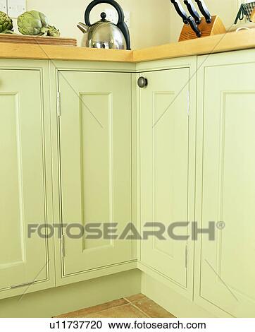 Stainless steel kettle kitchen cupboard painted with pastel green Farrow+Ball paint View Large Photo Image Stock Image - Stainless steel kettle kitchen cupboard painted with pastel green Farrow+Ball paint. Fotosearch
