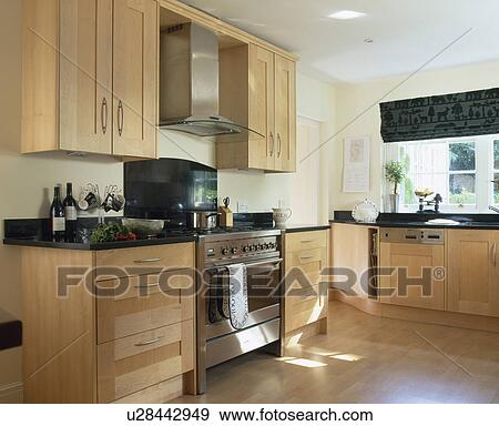 Stainless steel oven in modern kitchen with pale beech fitted units View Large Photo Image Stock Photo - Stainless steel oven in modern kitchen with pale beech fitted units. Fotosearch