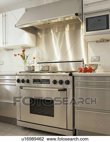 Stock Image - Stainless steel range oven and fitted units in modern kitchen. Fotosearch