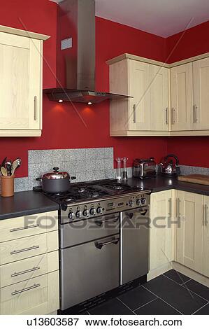 Stainless steel range oven in red kitchen with pale wood fitted cupboards View Large Photo Image Stock Photo - Stainless steel range oven in red kitchen with pale wood fitted cupboards. Fotosearch