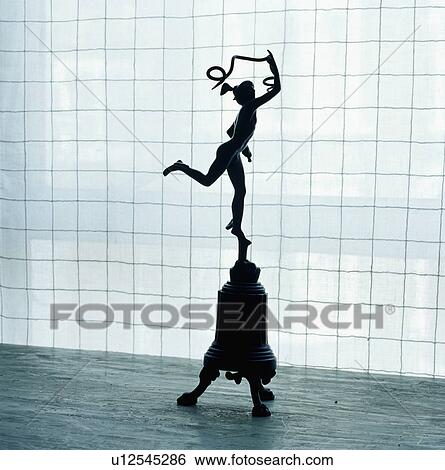 Statue of Eros on pedestal in front of white linen blind View Large Photo Image Stock Photograph - Statue of Eros on pedestal in front of white linen blind. Fotosearch