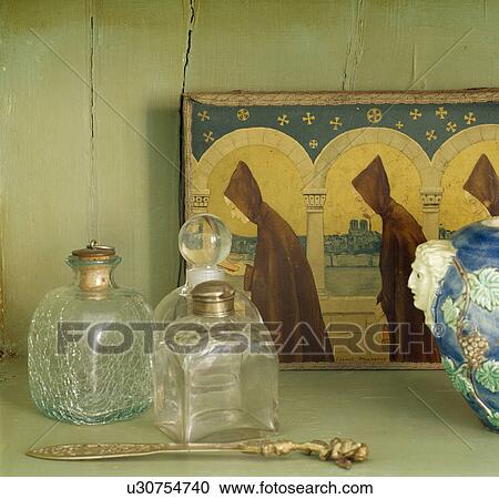 Still-life of antique glass scent bottles and small gold religious picture View Large Photo Image Stock Image - Still-life of antique glass scent bottles and small gold religious picture. Fotosearch