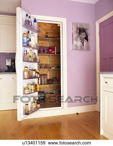 Stock Photo - Storage on open door to larder cupboard. Fotosearch