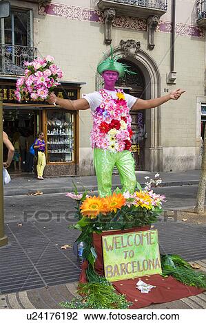 Stock Image - Street entertainer holding bouquet of flowers, La Rambla, Barcelona, Spain. Fotosearch