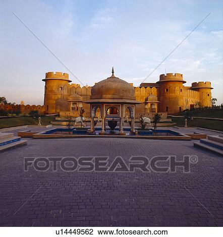 Stock Image - Sunset at old sandstone fort now the Rajvilas Hotel near Jaipur in Rajastan. Fotosearch