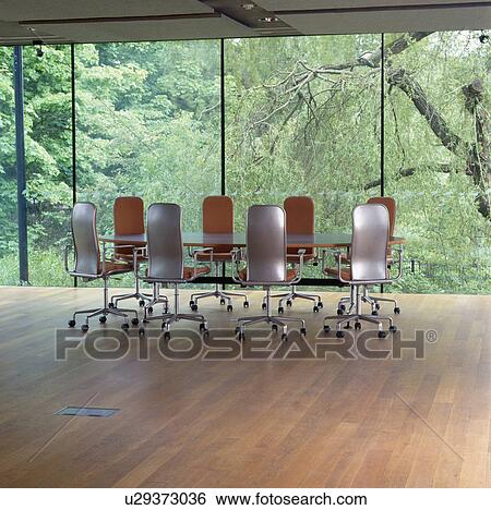 Swivel Office Chairs At Table In Minimalist Boardroom With Plate Glass Windows And Wooden Flooring Stock Photograph U29373036 Fotosearch