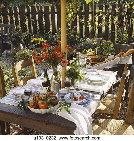 Table set for lunch on shady patio of house in the South of France View Large Photo Image Stock Image - Table set for lunch on shady patio of house in the South of France. Fotosearch