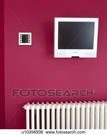 Television on red wall above white radiator View Large Photo Image Stock Photo - Television on red wall above white radiator. Fotosearch