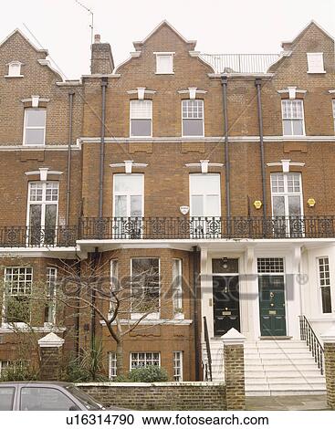 Stock Image - Terraced Edwardian townhouses with balconies and white steps to front doors. Fotosearch