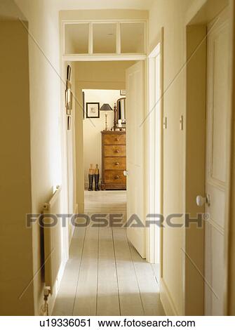Stock Image - Tiled floor in narrow hall corridor. Fotosearch