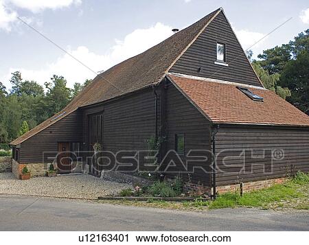 Stock Image - Timbered black barn conversion. Fotosearch