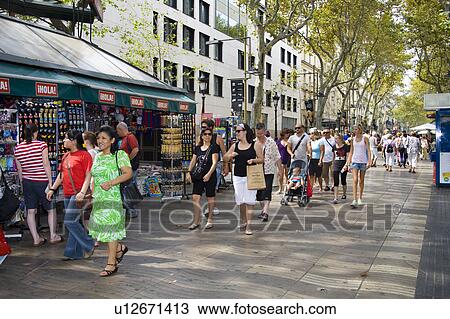 Stock Image - Tourists walking along La Rambla, Barcelona, Spain. Fotosearch