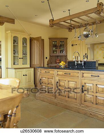 Stock Photo - Traditional country kitchen with chestnut wood fitted units. Fotosearch