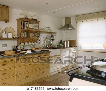 Traditional country kitchen with wooden plate rack above old pine chest of drawers View Large Photo Image Stock Image - Traditional country kitchen with wooden plate rack above old pine chest of drawers. Fotosearch