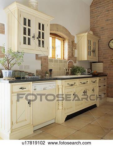 Stock Image - Traditional cream country kitchen. Fotosearch