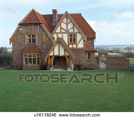 Traditional timbered new-build country house with newly-mown lawn and view of the countryside View Large Photo Image Stock Photograph - Traditional timbered new-build country house with newly-mown lawn and view of the countryside. Fotosearch