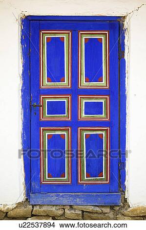 Traditionally painted blue wooden Romanian door with red and green detail View Large Photo Image Picture - Traditionally painted blue wooden Romanian door with red and green detail . Fotosearch