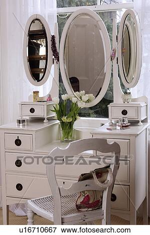 Triple Oval Mirrors On White Dressing Table With White Antique