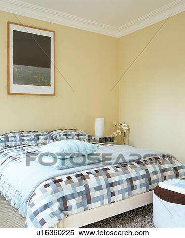 Turquoise throw and checked bedlinen on bed in modern bedroom View Large Photo Image Stock Photography - Turquoise throw and checked bedlinen on bed in modern bedroom. Fotosearch