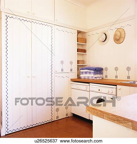Utility room with stencilled white fitted cupboards View Large Photo Image Stock Photo - Utility room with stencilled white fitted cupboards. Fotosearch