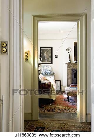 Stock Photography - View across landing through doorways to traditional country bedroom. Fotosearch