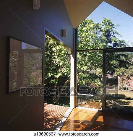 View of garden through glass doors of modern hall View Large Photo Image Stock Photo - View of garden through glass doors of modern hall. Fotosearch