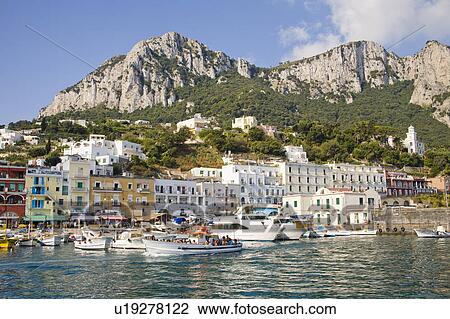 Stock Image - View of harbour, buildings and mountains from the sea, Marina Grande, Capri, Italy. Fotosearch