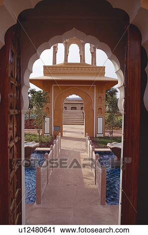 View through arched doorway to marble walkway over blue tiled pool at the Rajvilas Hotel near Jaipur in Rajastan View Large Photo Image Stock Image - View through arched doorway to marble walkway over blue tiled pool at the Rajvilas Hotel near Jaipur in Rajastan. Fotosearch