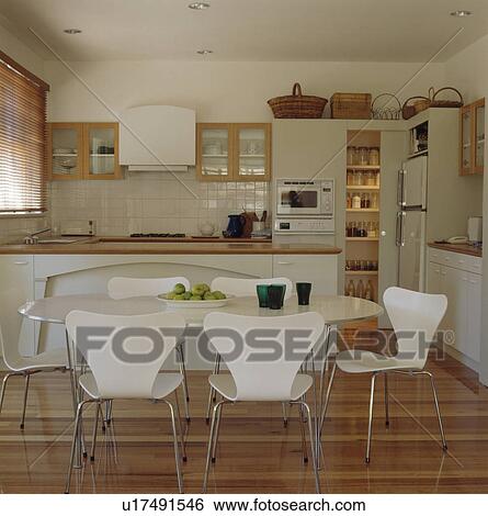 White Arne Jacobsen Ant chairs at table in dining area on modern white kitchen View Large Photo Image Stock Photograph - White Arne Jacobsen Ant chairs at table in dining area on modern white kitchen. Fotosearch