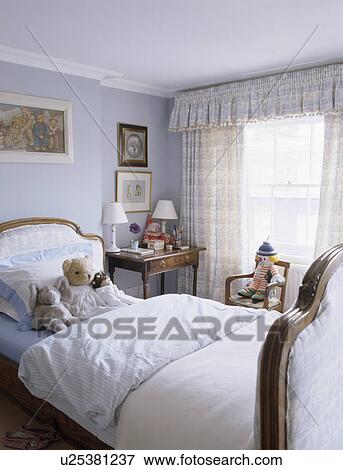 White bedlinen on upholstered bed in child's pastel blue bedroom View Large Photo Image Stock Photo - White bedlinen on upholstered bed in child's pastel blue bedroom. Fotosearch