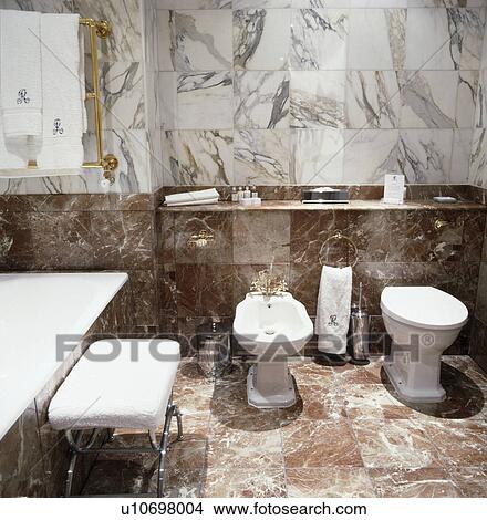 White bidet and toilet in marble townhouse bathroom View Large Photo Image Picture - White bidet and toilet in marble townhouse bathroom. Fotosearch