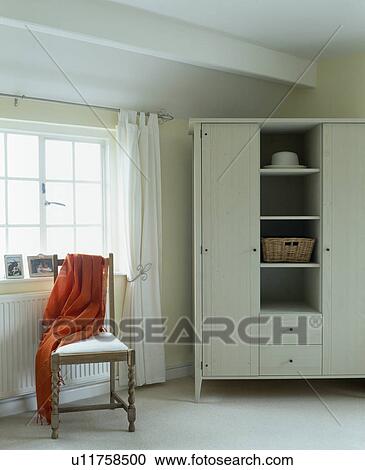 Stock Image - White cupboard in white bedroom. Fotosearch