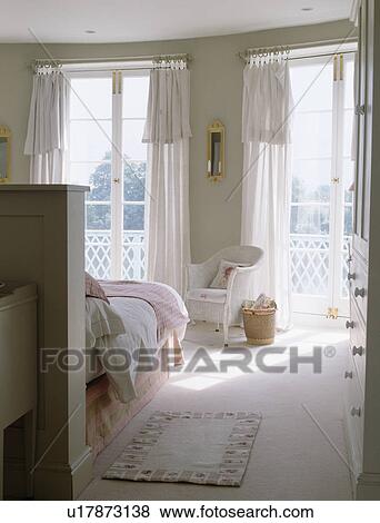 White curtains at French windows in airy white bedroom with white carpet View Large Photo Image Stock Photo - White curtains at French windows in airy white bedroom with white carpet. Fotosearch