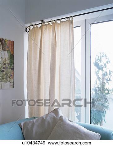 Stock Photo - White curtains on patio doors in modern living room. Fotosearch