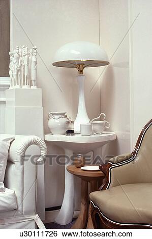 White dome-shaped lamp on small white table in sixties living room View Large Photo Image Stock Photograph - White dome-shaped lamp on small white table in sixties living room. Fotosearch