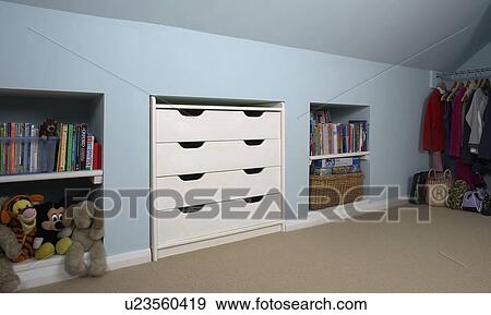 White fitted storage drawers and alcove shelves in pastel blue bedroom View Large Photo Image Stock Photo - White fitted storage drawers and alcove shelves in pastel blue bedroom. Fotosearch