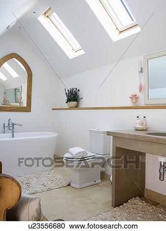 White freestanding bath in modern white attic bathroom with Velux windows View Large Photo Image Stock Image - White freestanding bath in modern white attic bathroom with Velux windows. Fotosearch