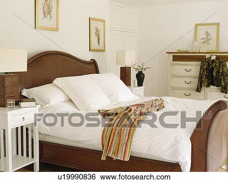White linen on mahogany bed in cream country bedroom View Large Photo Image Stock Photograph - White linen on mahogany bed in cream country bedroom. Fotosearch