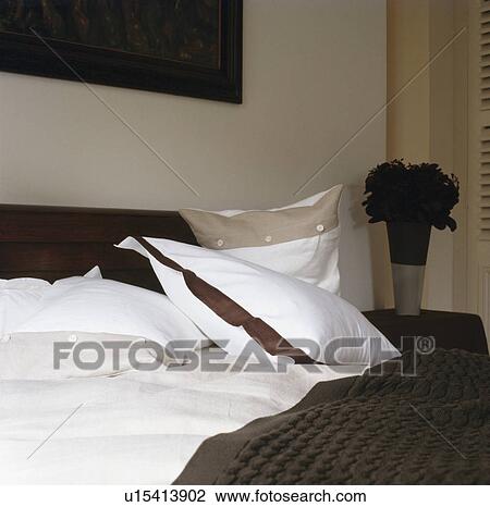 White pillows on bed with white linen and black bedcover in modern bedroom View Large Photo Image Stock Image - White pillows on bed with white linen and black bedcover in modern bedroom. Fotosearch
