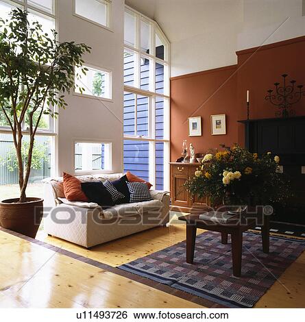 White sofa in large modern living room with terracotta wall View Large Photo Image Stock Photograph - White sofa in large modern living room with terracotta wall. Fotosearch
