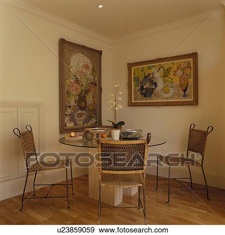 Stock Photo - Wicker chairs and circular table in modern dining room. Fotosearch