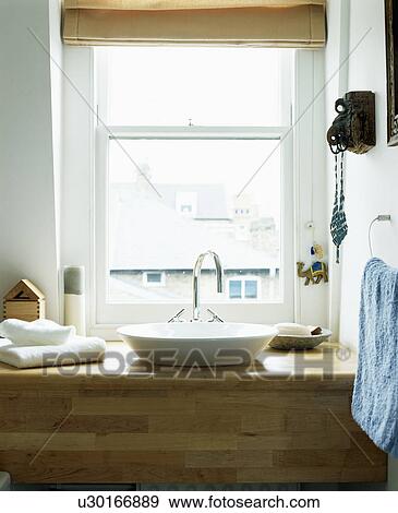 Stock Photo - Window above white basin on wooden shower unit. Fotosearch