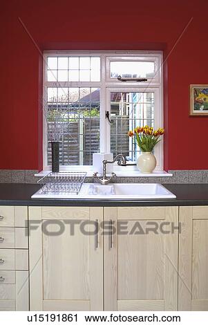 Finestra Sopra Lavello Cucina.Window Above White Sink In Red Kitchen With Pale Wood Units Stock Image U15191861 Fotosearch