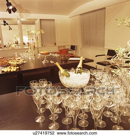 Wine glasses and champagne on table in modern dining room before a party View Large Photo Image Stock Image - Wine glasses and champagne on table in modern dining room before a party. Fotosearch