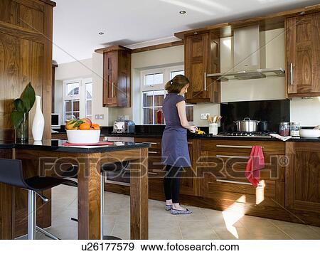 Woman chopping vegetables in modern kitchen View Large Photo Image Stock Photo - Woman chopping vegetables in modern kitchen. Fotosearch